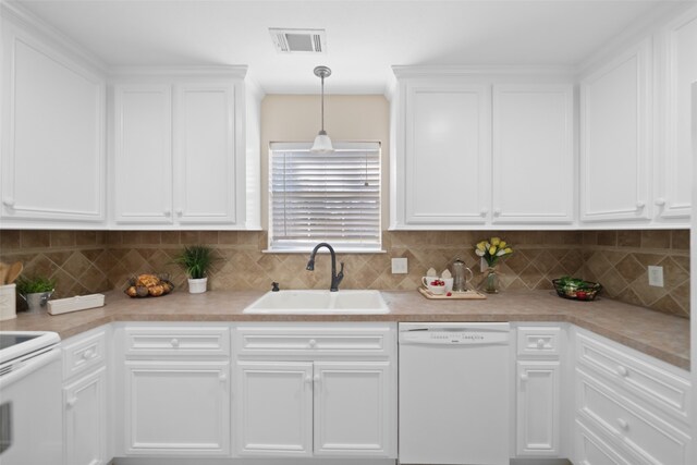 kitchen with white cabinetry, sink, hanging light fixtures, and white appliances