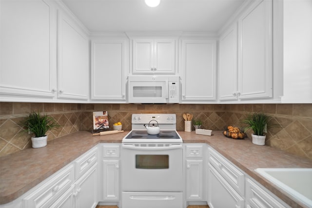 kitchen featuring white cabinetry, white appliances, and tasteful backsplash