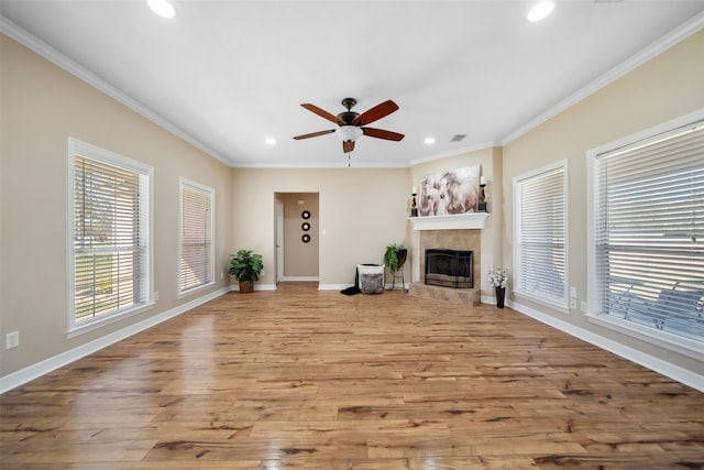 unfurnished living room with light hardwood / wood-style floors, ceiling fan, and crown molding