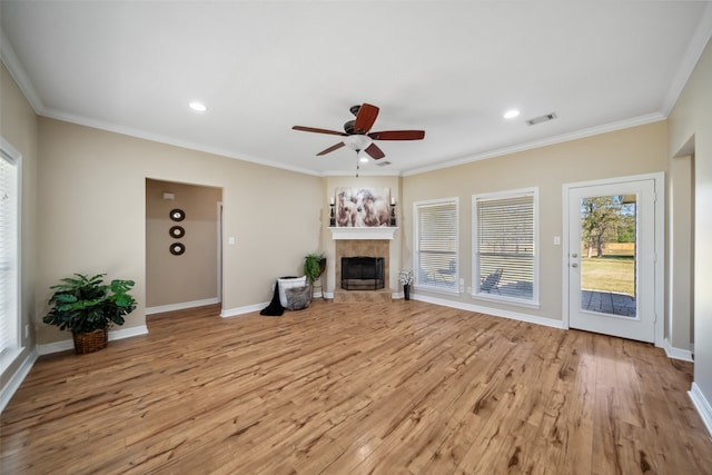 unfurnished living room with a fireplace, light hardwood / wood-style floors, and crown molding