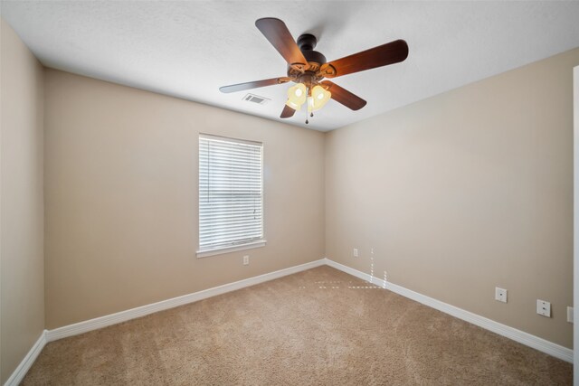 spare room with ceiling fan and carpet floors