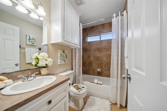 full bathroom with shower / tub combo, vanity, and toilet