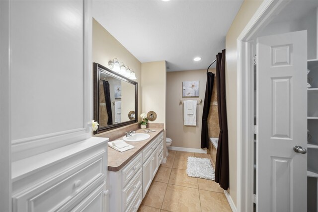 full bathroom with tile patterned floors, vanity, toilet, and shower / bath combo with shower curtain