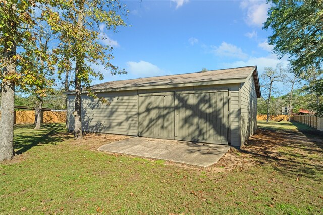 view of outbuilding featuring a lawn