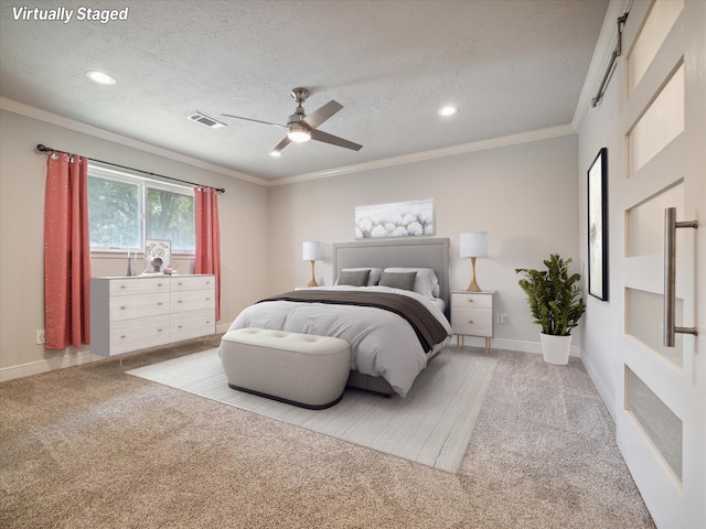 bedroom with light carpet, a textured ceiling, ceiling fan, and ornamental molding