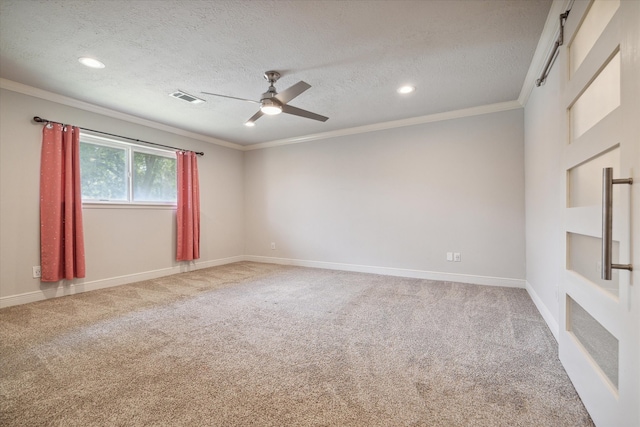 unfurnished room with carpet flooring, ceiling fan, ornamental molding, and a textured ceiling