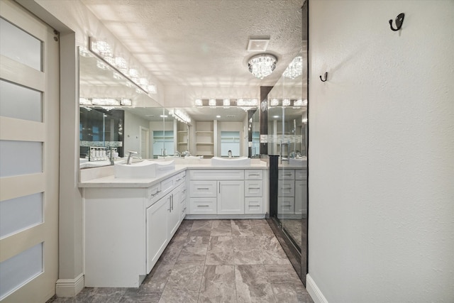 bathroom with vanity and a textured ceiling