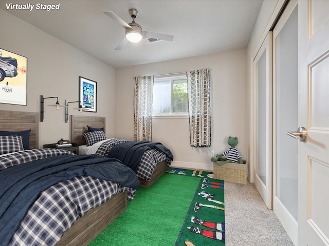 bedroom with ceiling fan, a closet, and carpet