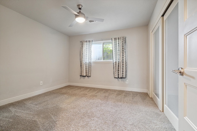 unfurnished bedroom featuring ceiling fan, carpet floors, and a closet