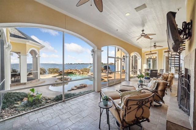 sunroom with a wealth of natural light and a water view