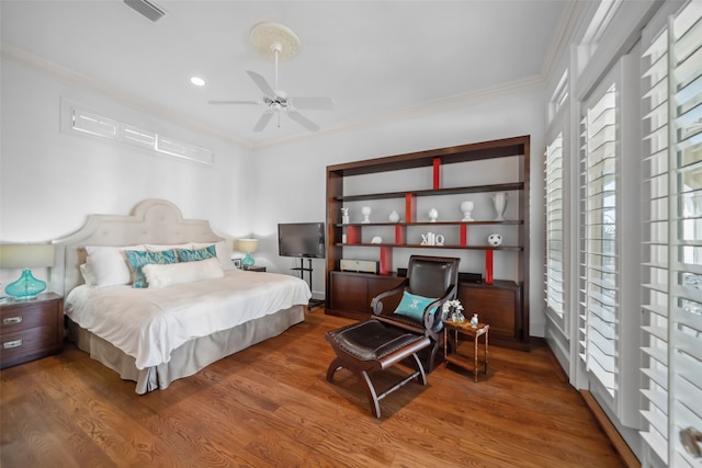 bedroom featuring ceiling fan, crown molding, and wood-type flooring