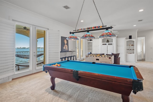 recreation room with light carpet, ceiling fan, crown molding, a water view, and billiards