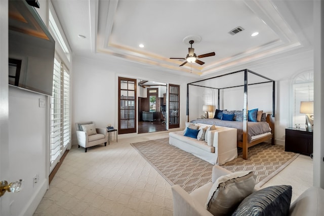 carpeted bedroom featuring french doors, a raised ceiling, ceiling fan, and crown molding