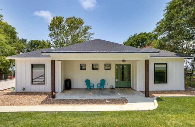 back of property with a yard and a patio area