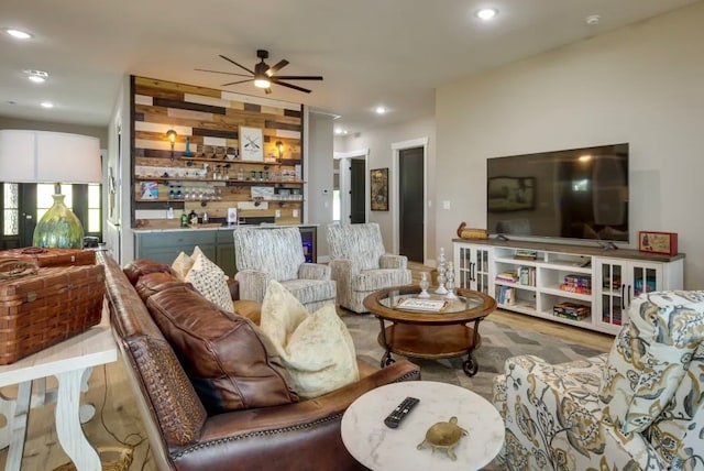 living room featuring wood-type flooring and ceiling fan