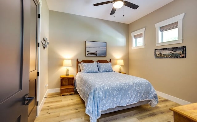 bedroom with ceiling fan and light wood-type flooring