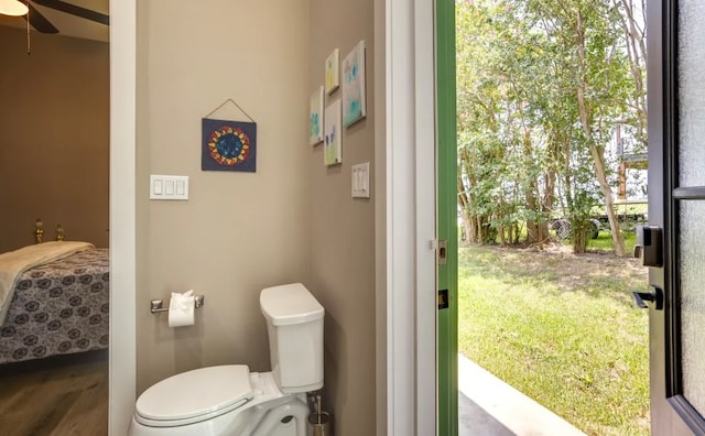 bathroom featuring ceiling fan, wood-type flooring, and toilet