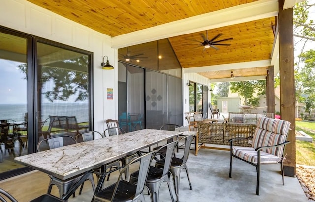 view of patio / terrace featuring ceiling fan, a water view, and an outdoor hangout area