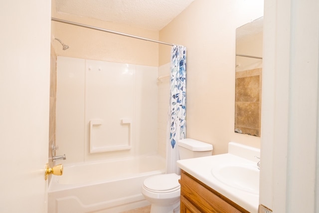 full bathroom featuring shower / tub combo, vanity, a textured ceiling, and toilet