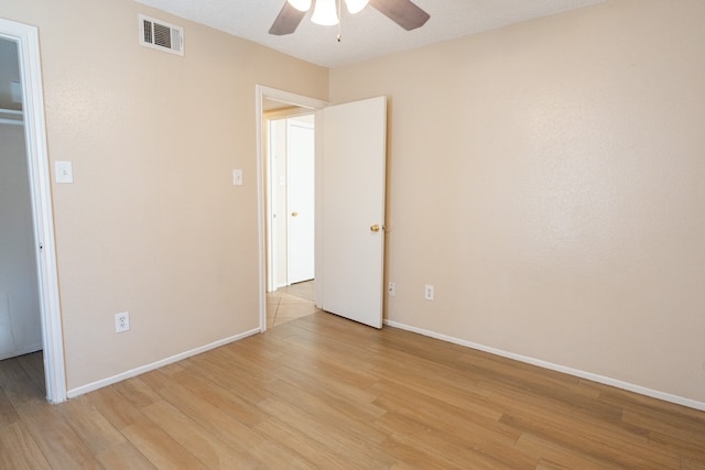 unfurnished bedroom with ceiling fan, light wood-type flooring, and a textured ceiling