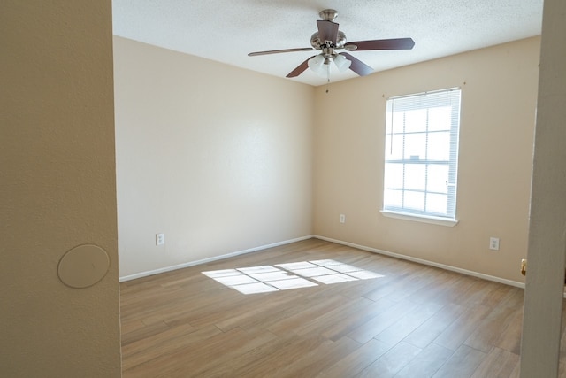 unfurnished room featuring ceiling fan, a textured ceiling, and light hardwood / wood-style flooring