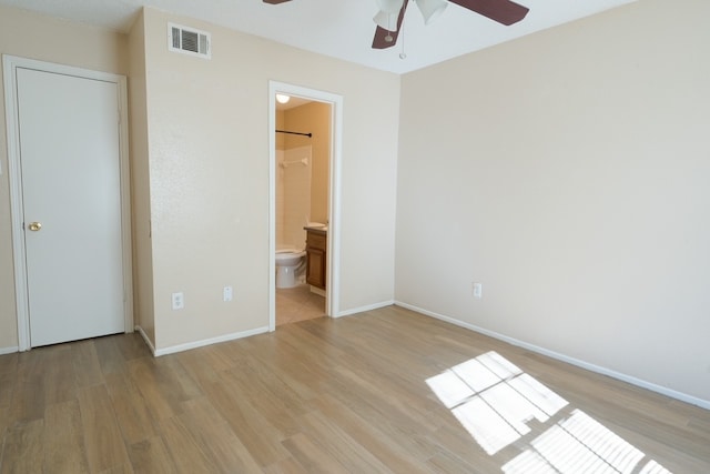 unfurnished bedroom featuring light hardwood / wood-style floors, ceiling fan, and ensuite bathroom