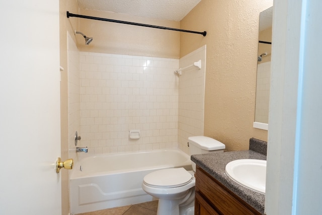 full bathroom featuring tile patterned floors, vanity, a textured ceiling, toilet, and tiled shower / bath