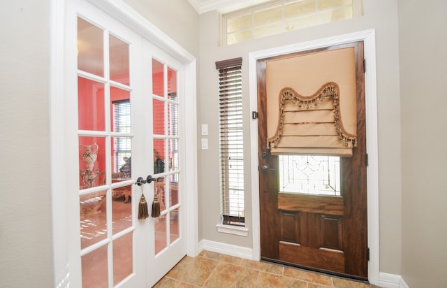 entryway with french doors, plenty of natural light, and ornamental molding