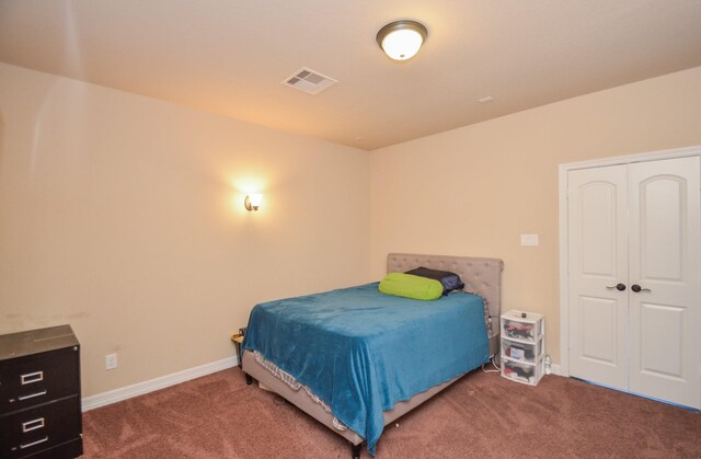 bedroom featuring a closet and dark colored carpet