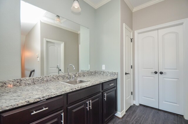 bathroom featuring vanity, hardwood / wood-style flooring, and ornamental molding