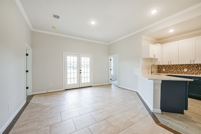 kitchen featuring sink, white cabinets, and ornamental molding