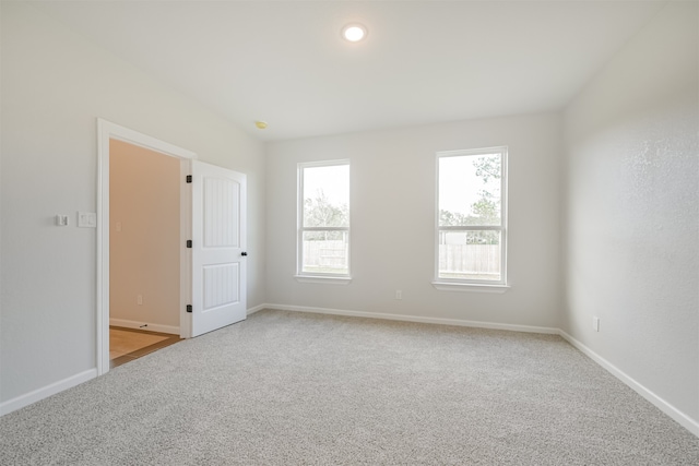 unfurnished room with light colored carpet