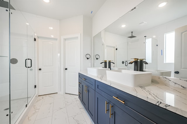 bathroom with vanity and a shower with shower door