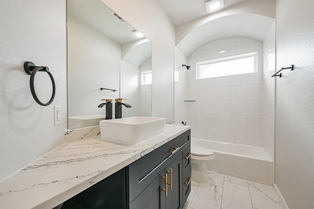 full bathroom featuring vanity, toilet, and tiled shower / bath combo