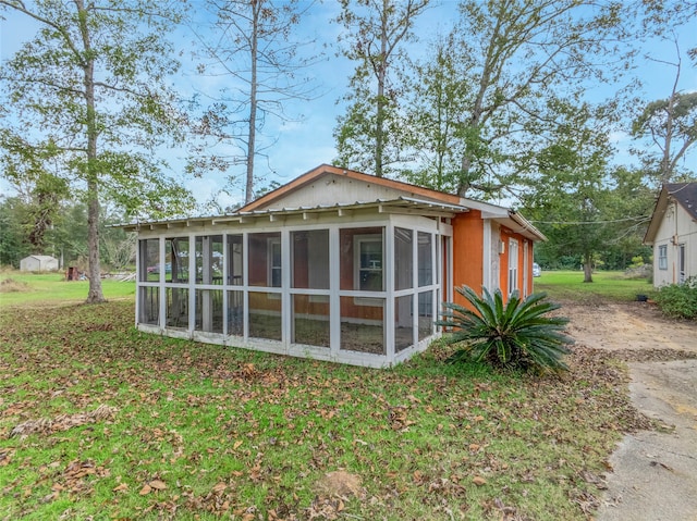 view of side of home featuring a sunroom