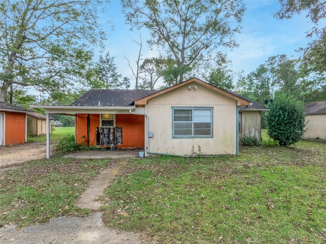 rear view of house with a lawn