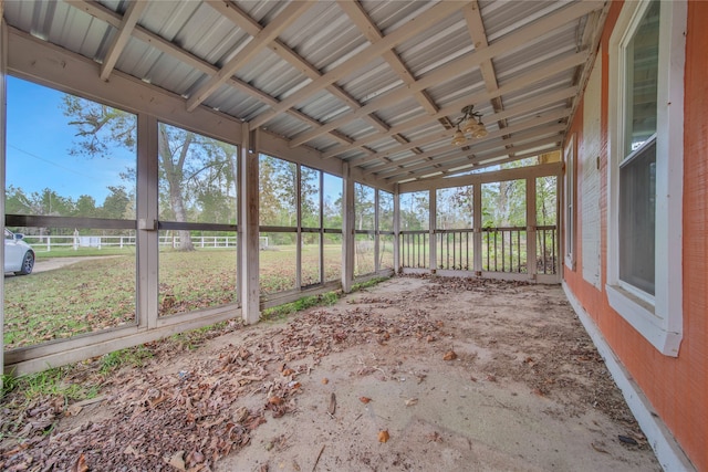 unfurnished sunroom featuring lofted ceiling