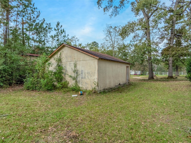 view of property exterior with a yard and an outdoor structure