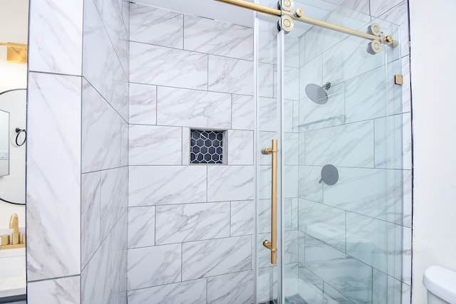 bathroom with toilet and an enclosed shower