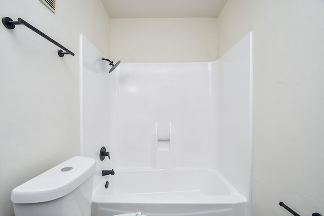 bathroom with bathtub / shower combination and toilet