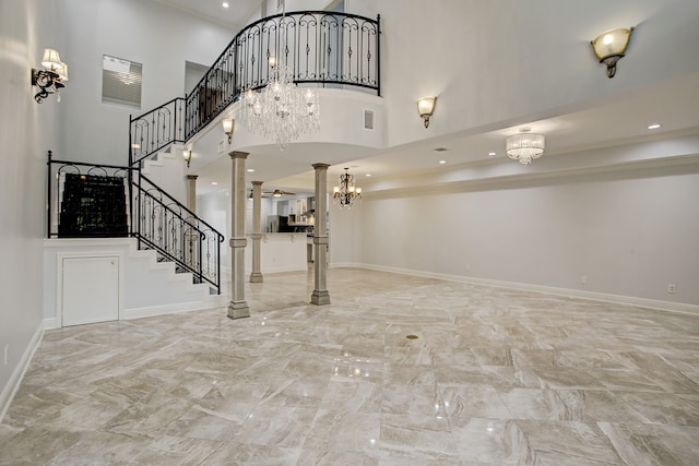 entryway with a high ceiling and decorative columns