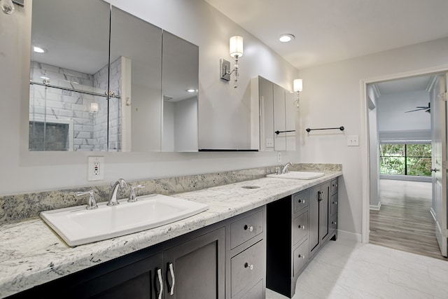 bathroom featuring hardwood / wood-style floors, vanity, and a shower with door