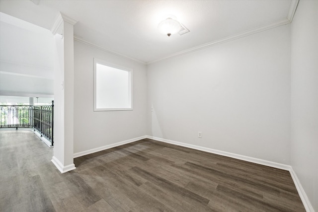 empty room with dark hardwood / wood-style flooring and ornamental molding