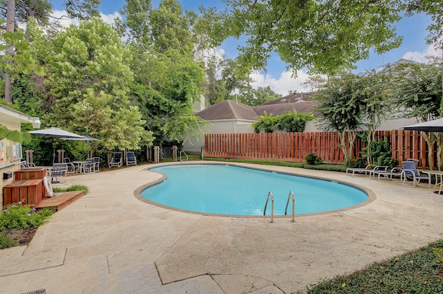 view of swimming pool with a patio area