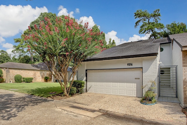 view of front of home with a garage and a front lawn