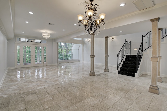 unfurnished living room with a notable chandelier, ornate columns, ornamental molding, and french doors