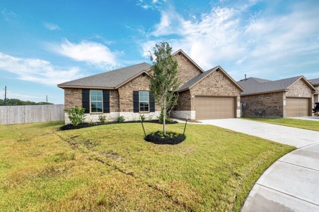 ranch-style home with a front yard, a garage, brick siding, concrete driveway, and fence