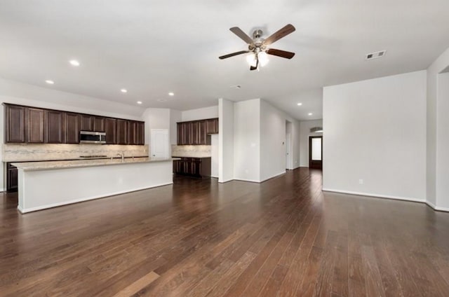 unfurnished living room featuring recessed lighting, a ceiling fan, visible vents, baseboards, and dark wood finished floors