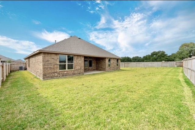 rear view of house featuring a lawn and a patio