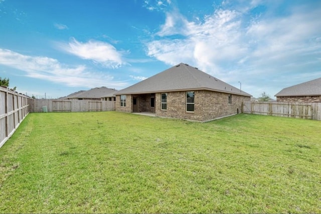 rear view of property featuring a yard